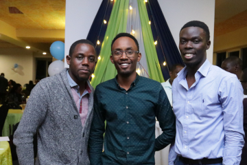 three black men smiling into the camera