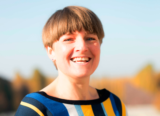 woman with short hair smiling in the camera