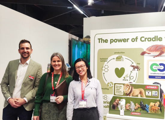 one man and two women staning at a booth stating "The power of Cradle"